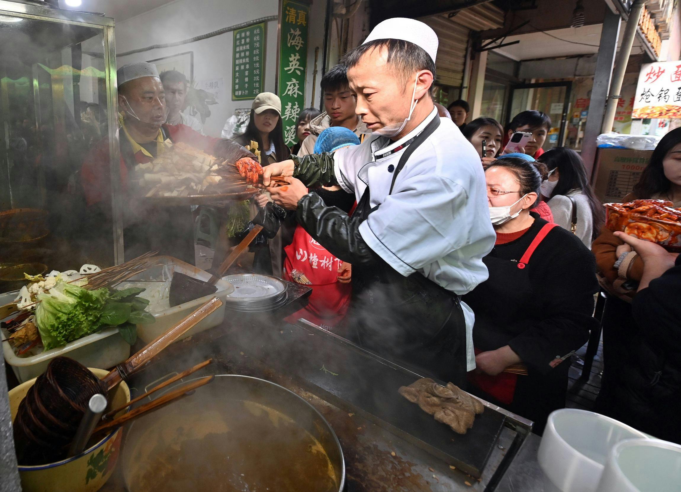Ein Mitarbeiter kocht am 14. März 2024 in der Stadt Tianshui in der chinesischen Provinz Gansu den Tianshui Spicy Hot Pot