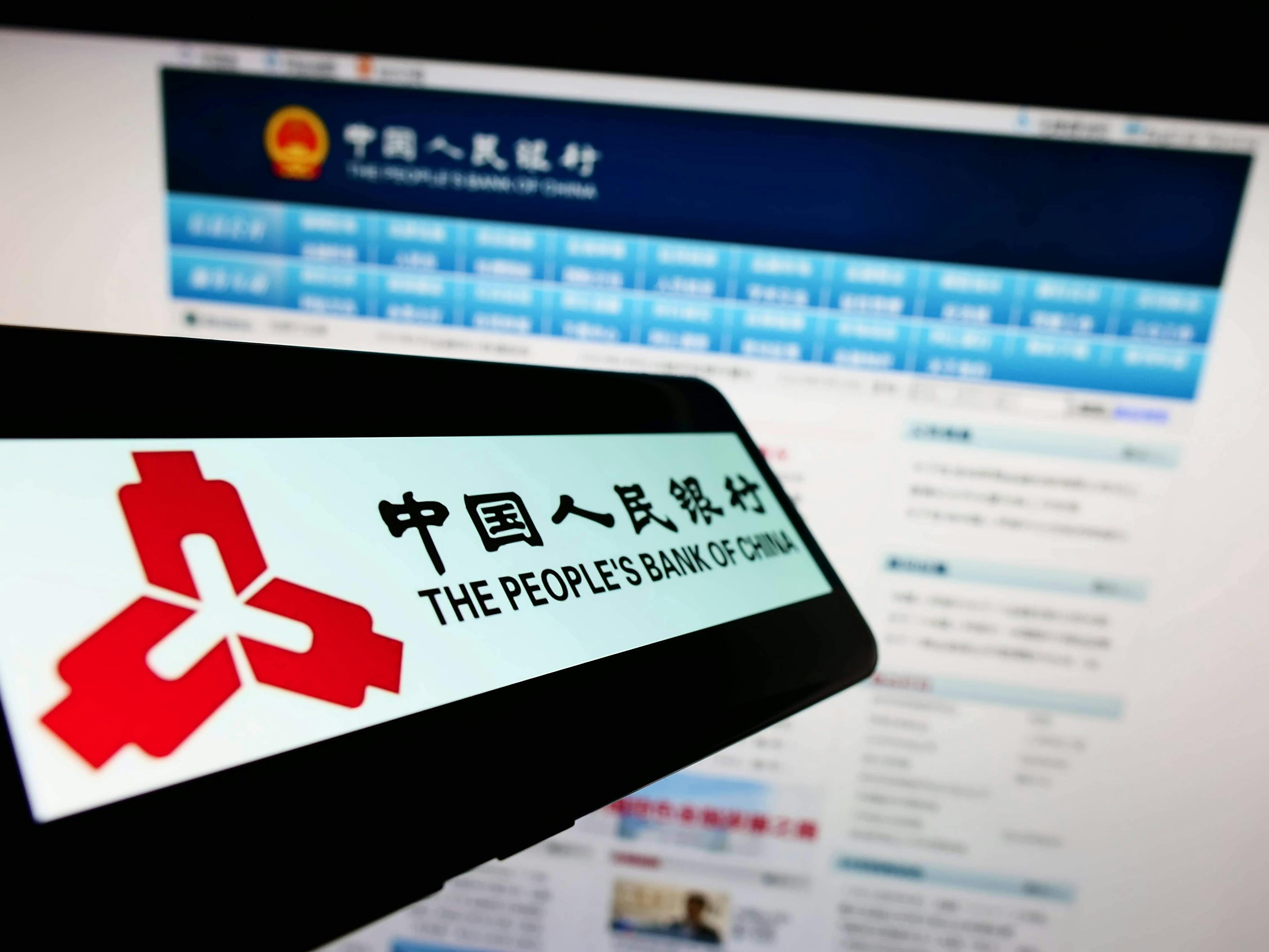 Smartphone with logo of financial institution People s Bank of China on screen in front of website. Stuttgart, Germany
