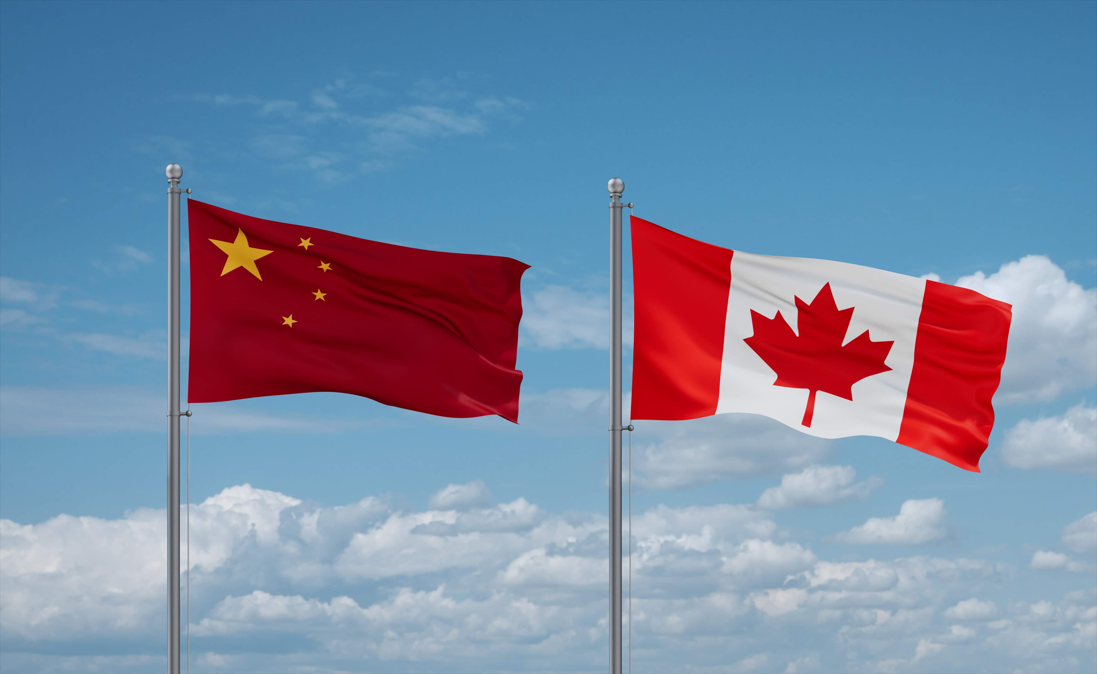 Canada and China flags waving together in the wind on blue cloudy sky, two country relationship concept Model Released