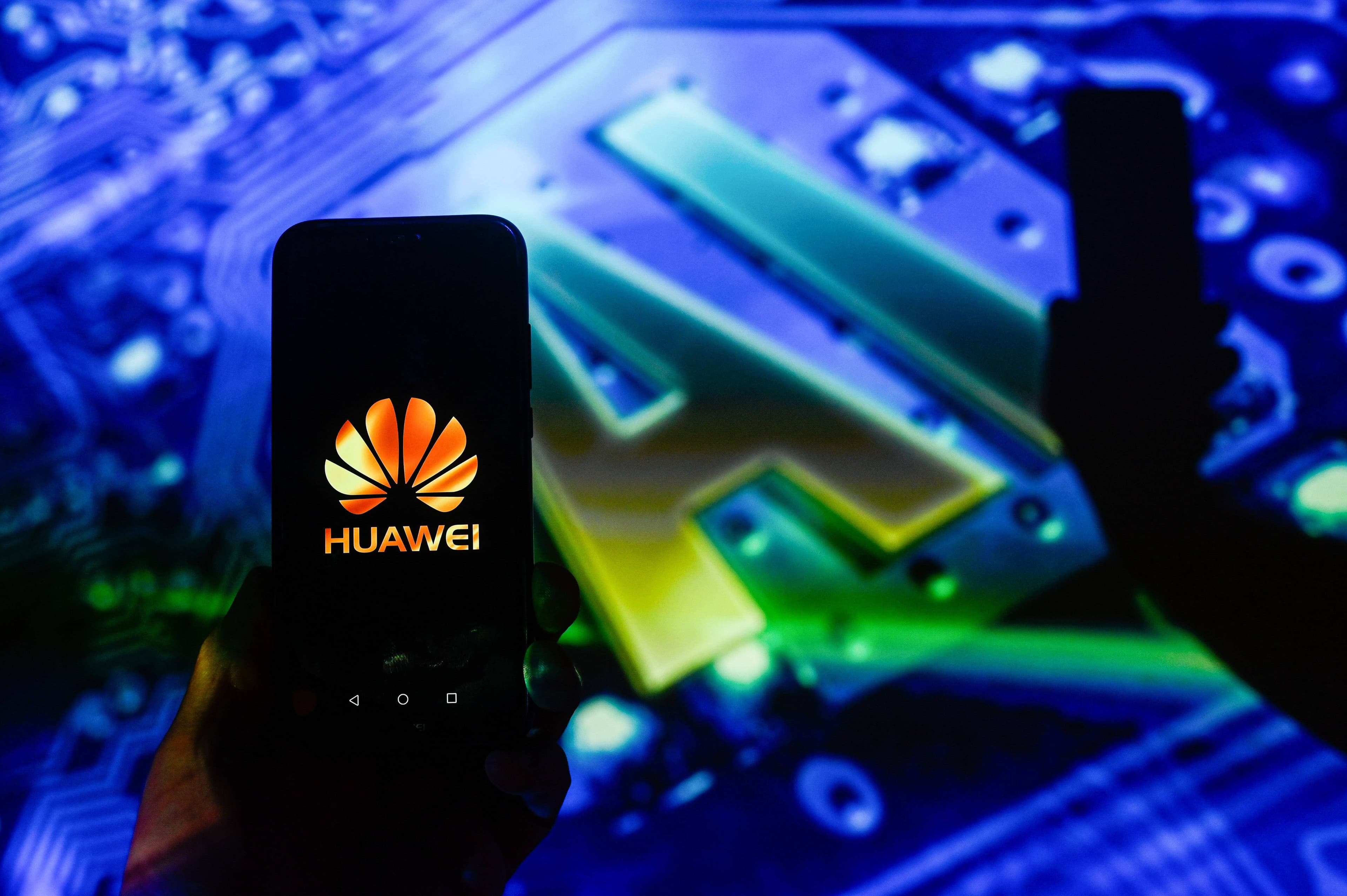 In this photo illustration, a Huawei logo is displayed on a smartphone with Artificial Intelligence symbol (AI) in the background.