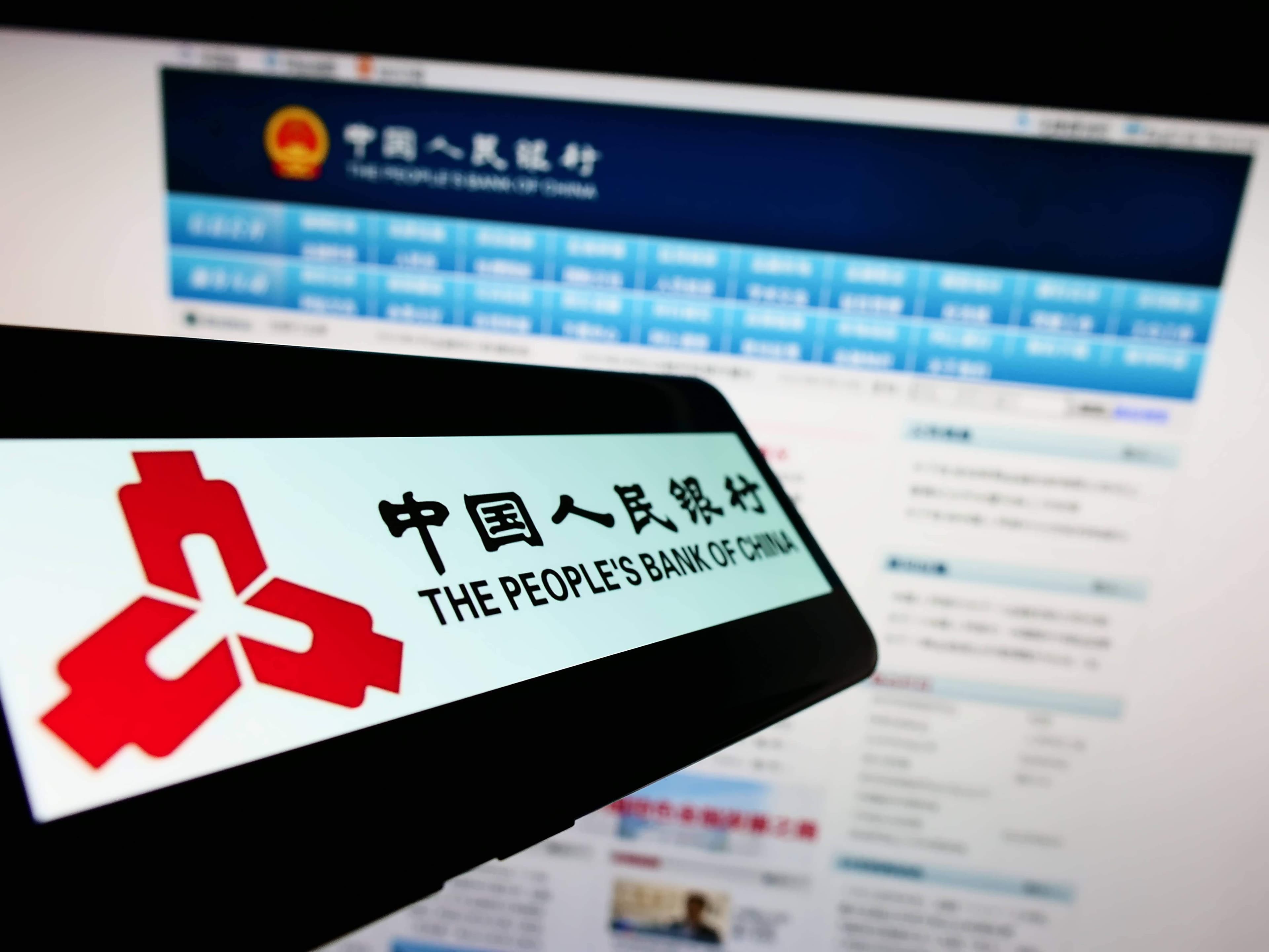 Smartphone with logo of financial institution People s Bank of China on screen in front of website. Stuttgart, Germany